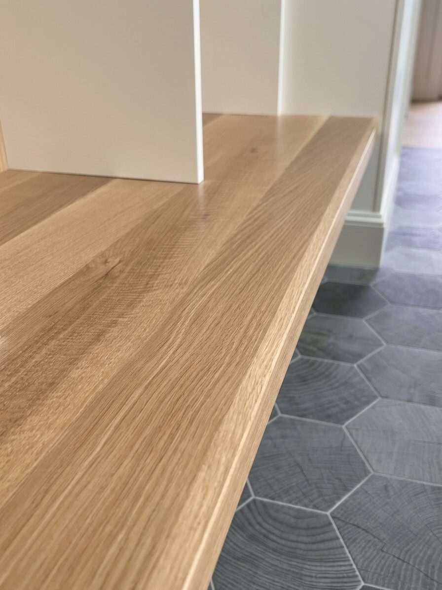 Close-up of the rift white oak bench top grain against hexagonal floor tile