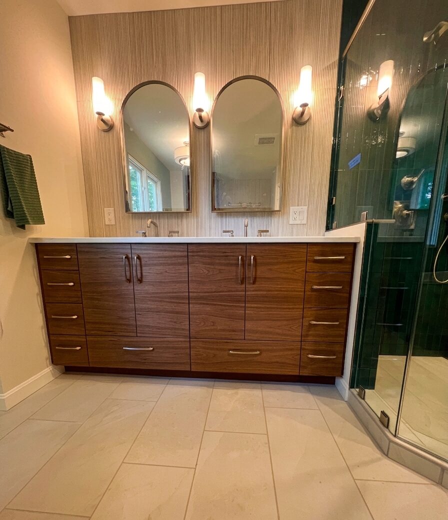 Custom walnut double vanity with grain-matched drawer and door fronts