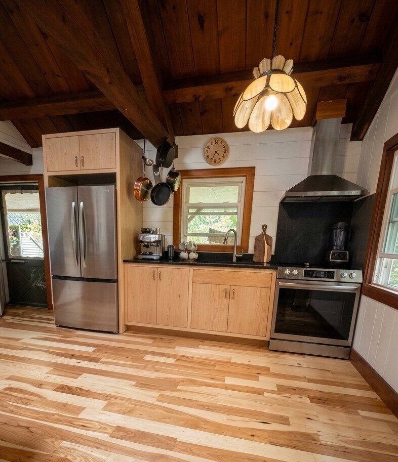 Full kitchen run with maple cabinetry, stainless refrigerator, and range